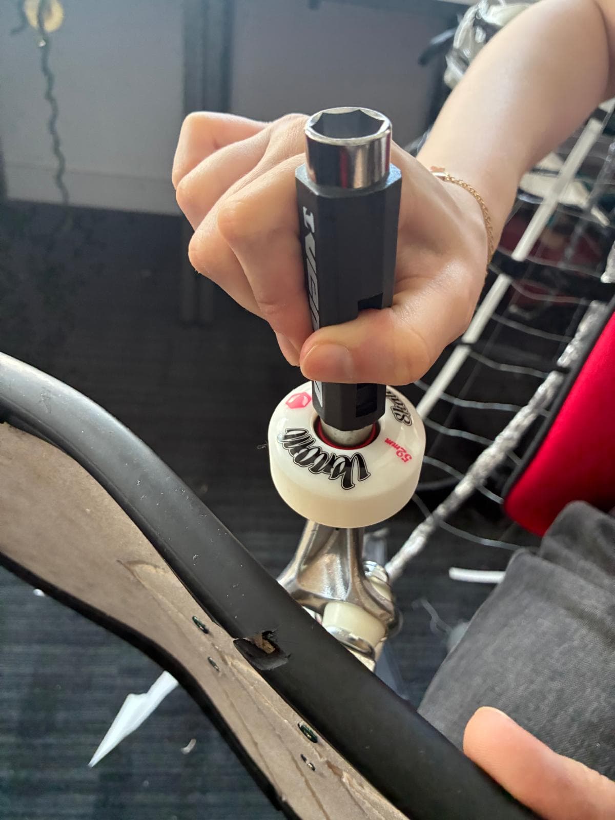 Skateboard wheel and truck being assembled onto the finished deck