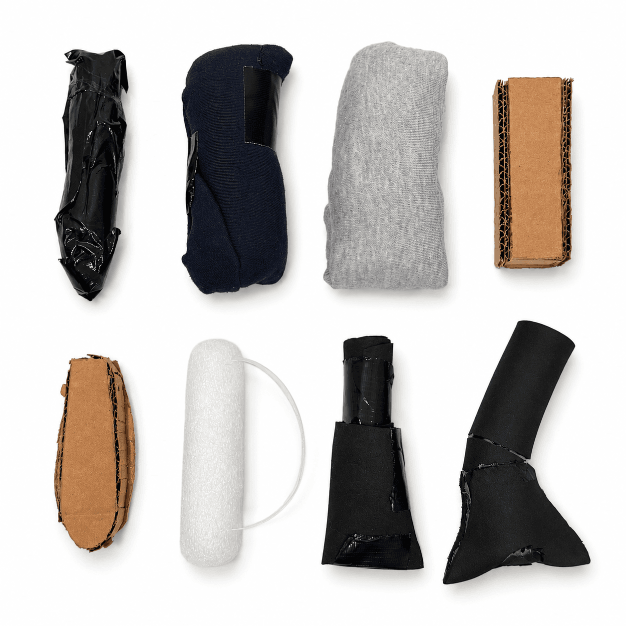 Eight low-fidelity handle prototypes made from foam, fabric, card and tape